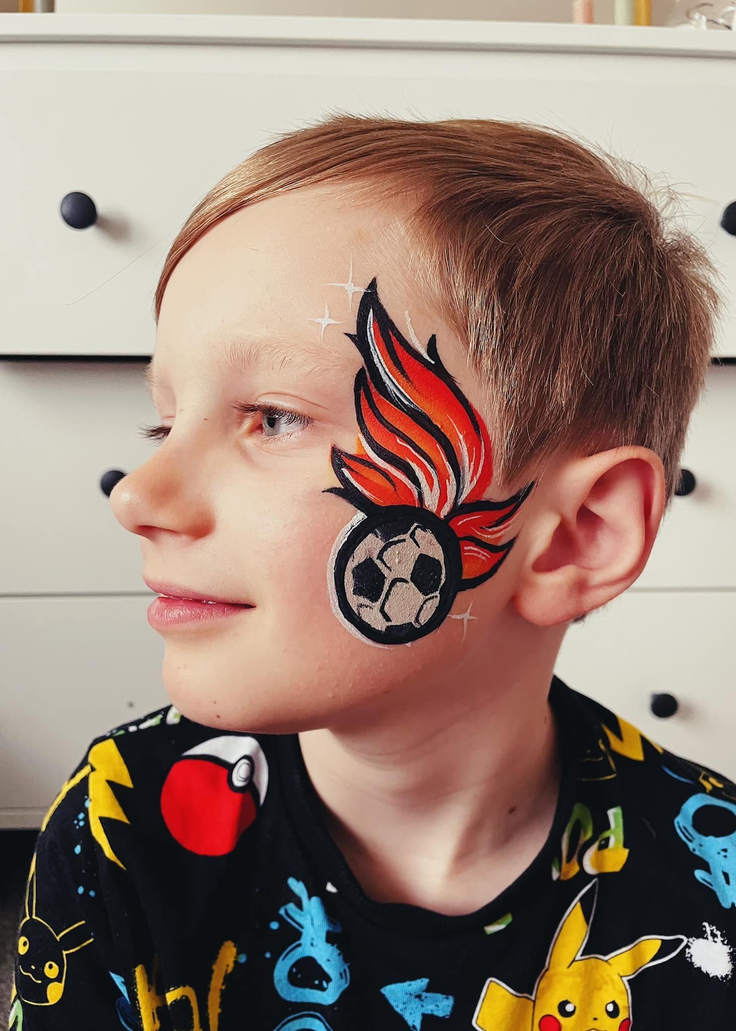Flaming football face paint on a young boy